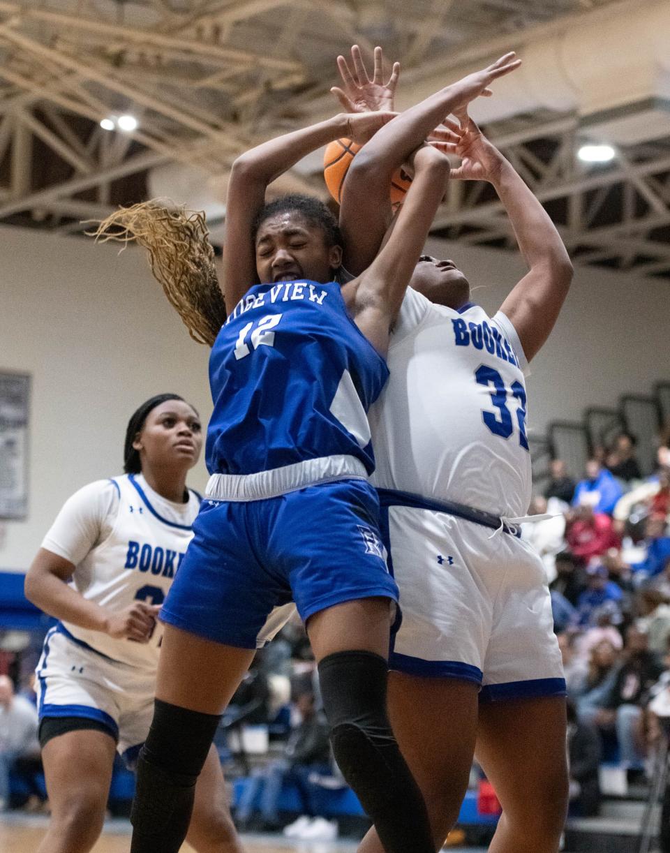 Narissa Blocton (12) and Mi'kel Bonner (32) get tangled up while pursuing a rebound in the Region 1-5A playoff.