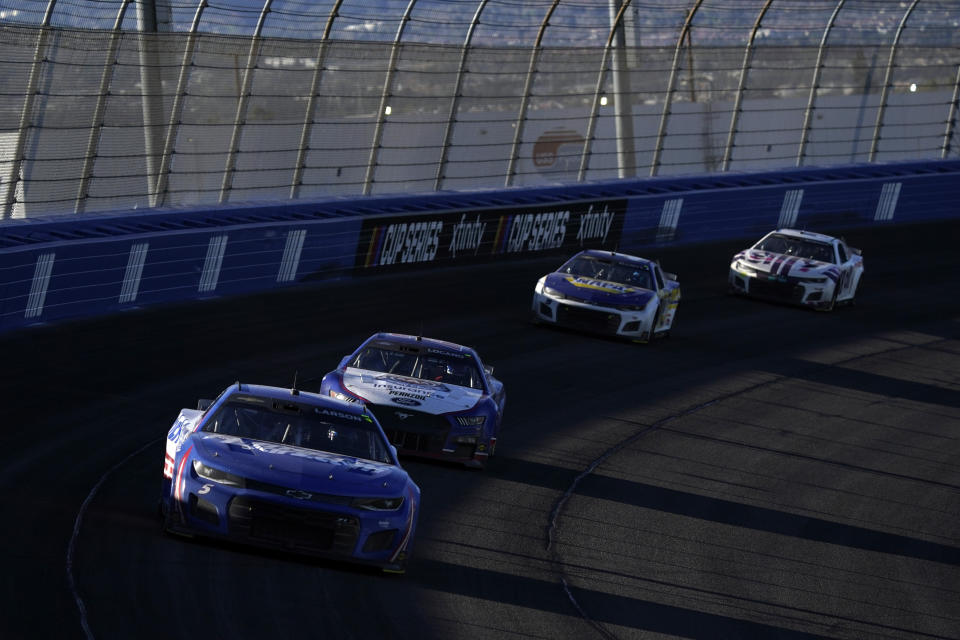 From left, Kyle Larson races ahead of Joey Logano, Chase Elliott and Alex Bowman during the NASCAR Cup Series auto race at Auto Club Speedway Sunday, Feb. 27, 2022, in Fontana, Calif. Kyle Larson sent an infuriated Chase Elliott into the fence when they made contact Sunday with just under 20 laps to go at Auto Club Speedway. Elliott's bold move to take the lead was erased when Larson, who had been side drafting off Joey Logano to stay in front, came briskly up the track and pinched Elliott into the wall.(AP Photo/Marcio Jose Sanchez)