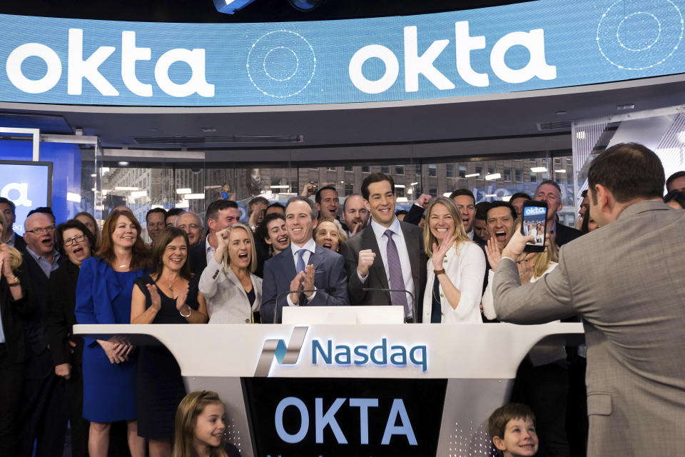 Okta CEO Todd McKinnon, center right, and COO Frederic Kerrest, center left, react after ringing the opening bell to celebrate Okta's initial public offering, at NASDAQ on Friday, April 7, 2017 in New York. (Charles Sykes/AP Images for OKTA)