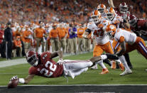 FILE - In this Jan. 7, 2019, file photo, Alabama's Najee Harris reaches for the end zone during the first half the NCAA college football playoff championship game against Clemson, in Santa Clara, Calif. After the Power Five conference commissioners met Sunday, Aug. 9, 2020, to discuss mounting concern about whether a college football season can be played in a pandemic, players took to social media to urge leaders to let them play.(AP Photo/David J. Phillip, File)