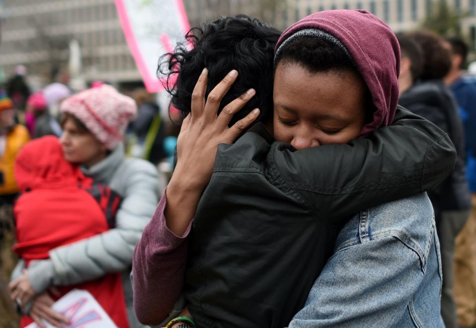 Demonstrators hug during protests on the National Mall in Washington, D.C., on Jan. 21, 2017.