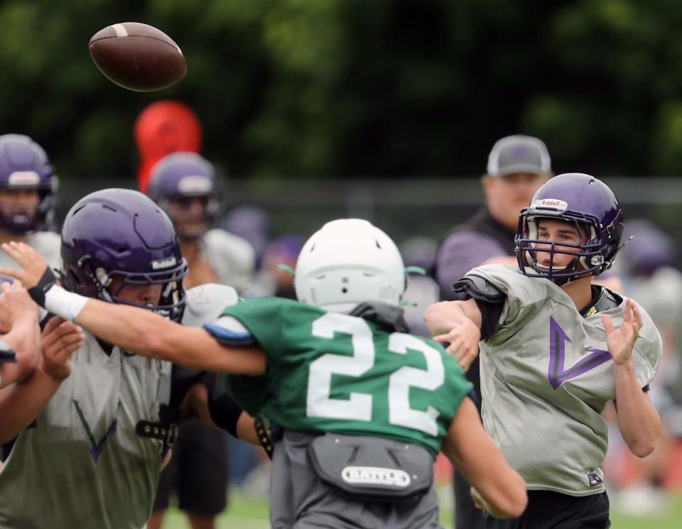 North Kitsap quarterback Cole Edwards passes the ball as the Vikings offense takes on the Peninsula Seahawks defense during the South Kitsap spring football scrimmage in Port Orchard on June 14.