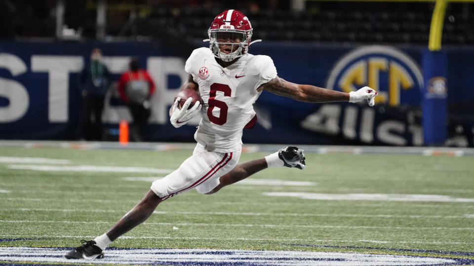 FILE - In this Saturday, Dec. 19, 2020, file photo, Alabama wide receiver DeVonta Smith (6) runs against Florida during the first half of the Southeastern Conference championship NCAA college football game in Atlanta. Smith has been named a finalist for the Heisman Trophy. The Heisman will be awarded Jan. 5 during a virtual ceremony as the pandemic forced the cancellation of the usual trip to New York that for the presentation that usually comes with being a finalist.  (AP Photo/Brynn Anderson, File)