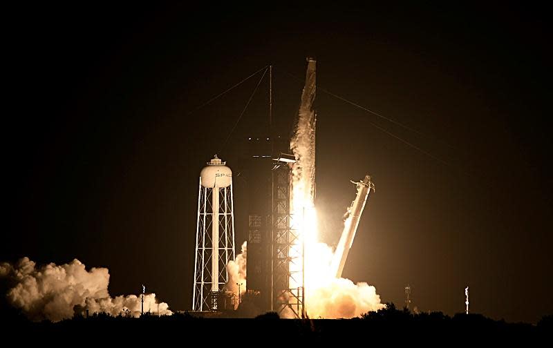 A SpaceX Falcon 9 rocket lights up the pre-dawn sky as it climbs away from the Kennedy Space Center early Sunday, boosting a Dragon cargo ship into orbit for a supply run to the International Space Station. / Credit: William Harwood/CBS News