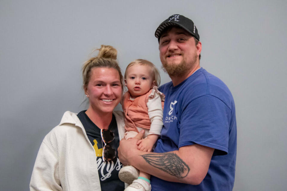 A couple holding a small child