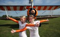 Nine-year-old cousins Rose Powell (left) and Flame Brewer prepare to go wing-walking over Rendcomb Airfield near Cirencester for the charity Duchenne Children's Trust.