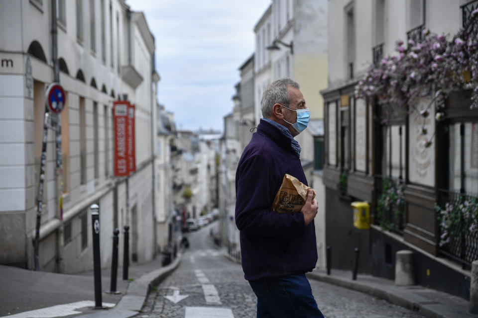 PARIS, FRANCE - OCTOBER 30: A man walks at empty street after France on Friday entered the second national lockdown imposed to stem the spread of the novel coronavirus in Paris, France on October 30, 2020. (Photo by Julien Mattia/Anadolu Agency via Getty Images)