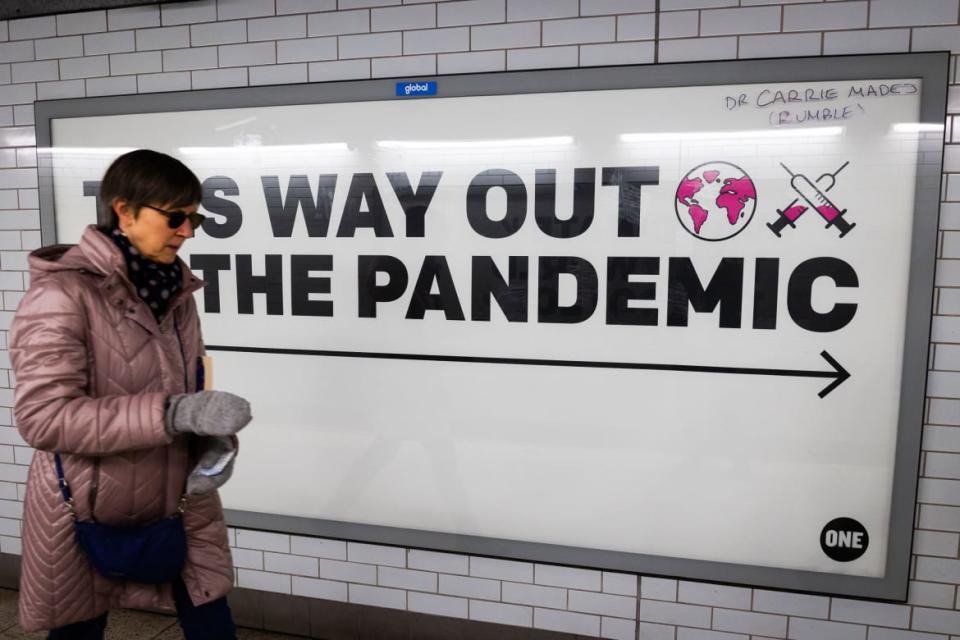 <div class="inline-image__caption"><p>A woman walks past a sign promoting vaccinations at Westminster Station in London. Testers first detected XE in the United Kingdom back in mid-January. Six weeks later, U.K. authorities had identified 600 XE infections.</p></div> <div class="inline-image__credit">Tejas Sandhu/Getty</div>