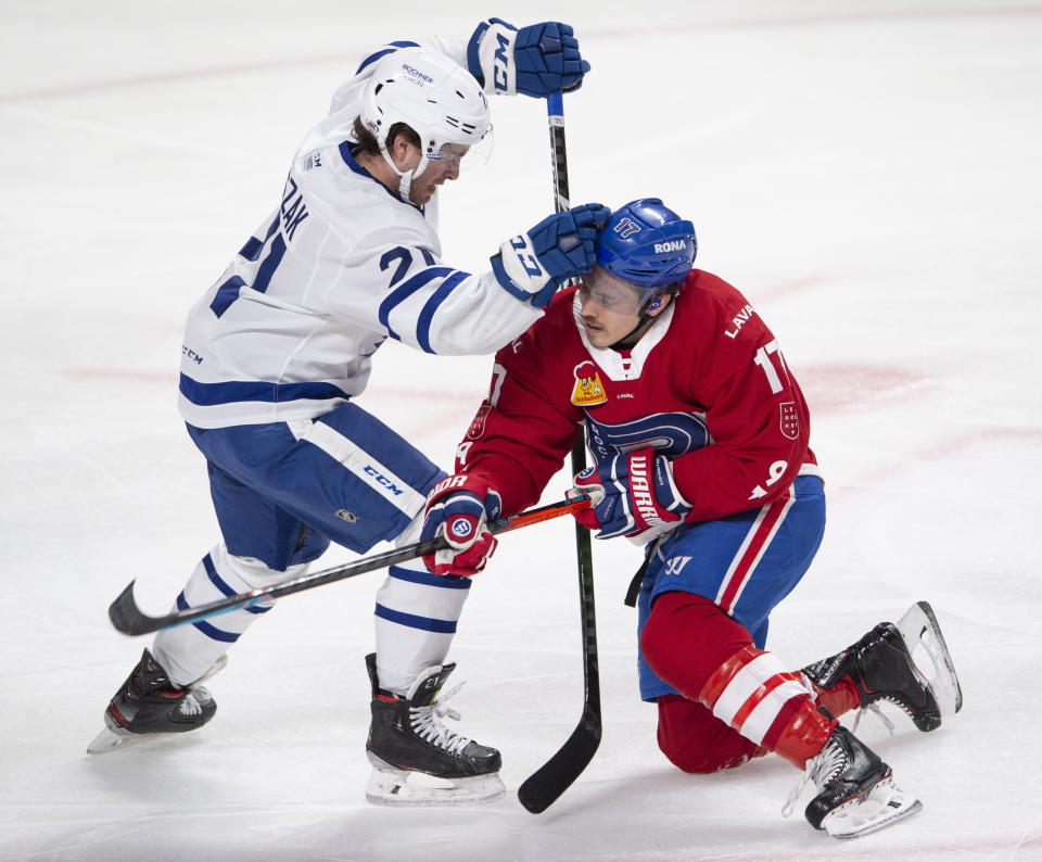 Laval Rocket's Brendan Gallagher, right, is checked by Toronto Marlies' Joseph Duszak during first-period American Hockey League action in Montreal, Monday, May 17, 2021. Carey Price and Gallagher are on a one-game conditioning loan to the Rocket before their playoff series against the Toronto Maple Leafs. (Ryan Remiorz/The Canadian Press via AP)