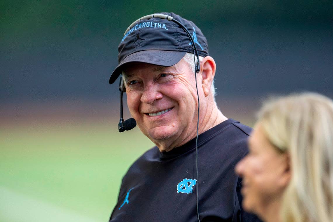 North Carolina coach Mack Brown talks with his wife Sally during the Tar Heels’ first practice of the season on Monday, July 29, 2024 in Chapel Hill, N.C.