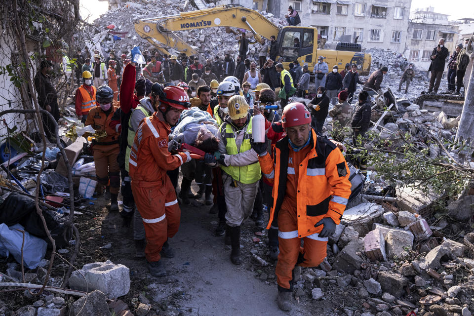 Rescue workers and medics pull out a person from a collapsed building in Antakya, Turkey, Wednesday, Feb. 15, 2023. More than 35,000 people have died in Turkey as a result of last week's earthquake, making it the deadliest such disaster since the country's founding 100 years ago. (Ugur Yildirim/DIA via AP)