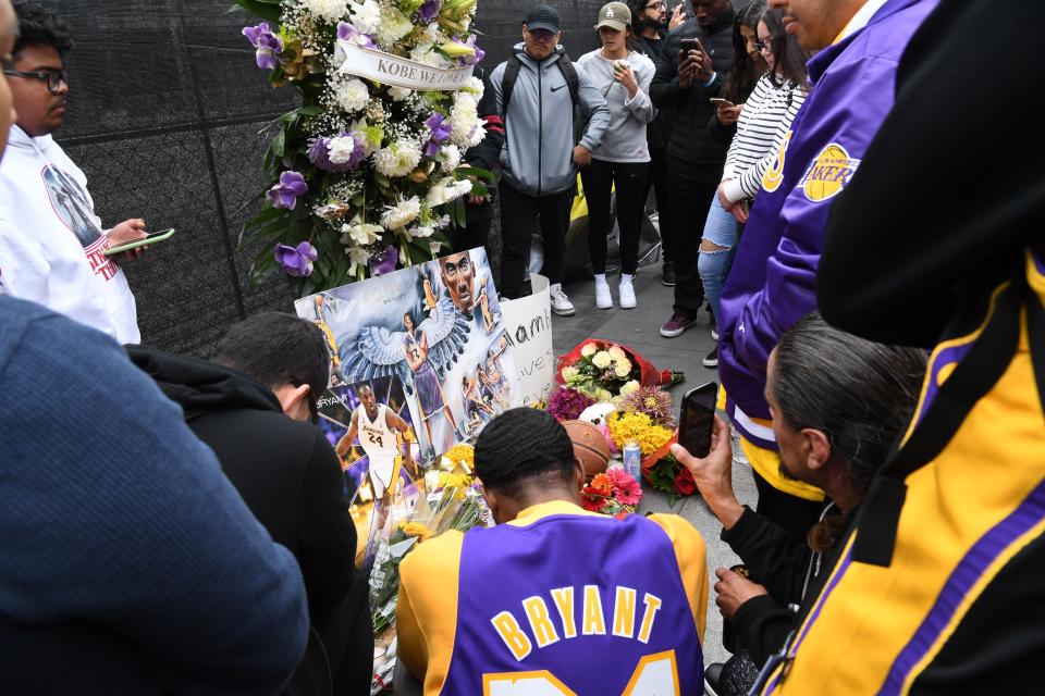 LOS ANGELES, CALIFORNIA - JANUARY 26: Flowers and tributes are left at a makeshift memorial for former NBA player Kobe Bryant outside the 62nd Annual GRAMMY Awards at STAPLES Center on January 26, 2020 in Los Angeles, California. Bryant, 41, and his daughter died in a helicopter crash earlier today in Calabasas, California. (Photo by Kevin Mazur/Getty Images)