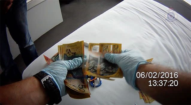 $158,000 was allegedly found during the raid at Surfers Paradise. Source: Queensland Police