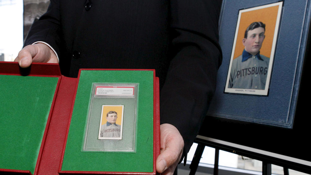 Photo by Paul Buck/EPA/REX/Shutterstock The T206 Honus Wagner Baseball Card is Displayed by Auction Company Officials at a Dodger Stadium Press Conference Announcing the Sale of the Card in Los Angeles California