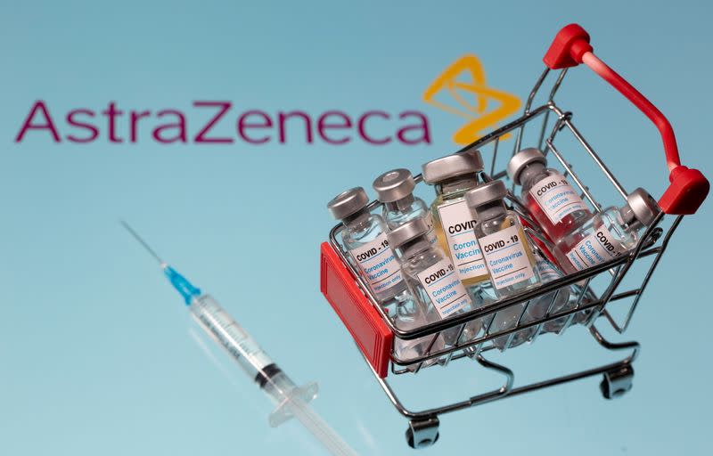 FILE PHOTO: A small shopping basket filled with vials labeled "COVID-19 - Coronavirus Vaccine" and a medical sryinge are placed on a AstraZeneca logo