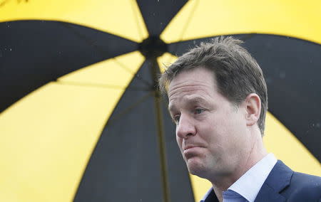 Britain's Liberal Democrat leader Nick Clegg speaks to journalists after unveiling a new campaign poster in the car park of a pub in Hyde, in Cheshire, Northern England, in this April 3, 2015 file photo. REUTERS/Andrew Yates