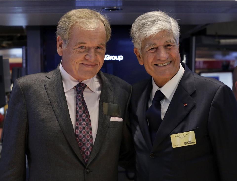 FILE - This July 29, 2013, file photo shows Omnicom Group President and CEO John Wren, left, and Publicis Groupe Chairman and CEO Maurice Levy pose for photos on the floor of the New York Stock Exchange in New York City. The CEO of Publicis Groupe, Maurice Levy, says the planned deal with Omnicom to create the world's largest advertising firm collapsed over unresolvable differences over how to implement a "merger of equals." The merger announced in July was intended to help the firms counter the growing clout of Internet giants such as Facebook and Google, which can bypass advertising companies altogether, as well as strengthen growth in Asia and Latin America. (AP Photo/Richard Drew, File)