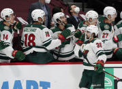 Minnesota Wild right wing Mats Zuccarello, front, is congratulated as he passes the team box after scoring a goal against the Colorado Avalanche in the first period of an NHL hockey game Wednesday, Feb. 24, 2021, in Denver. (AP Photo/David Zalubowski)