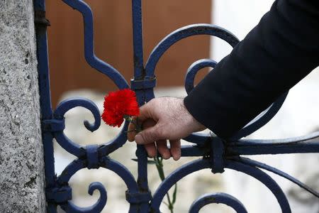 A man places a flower at the Obelisk of Theodosius, the scene of the suicide bomb attack, at Sultanahmet square in Istanbul, Turkey January 13, 2016. REUTERS/Osman Orsal