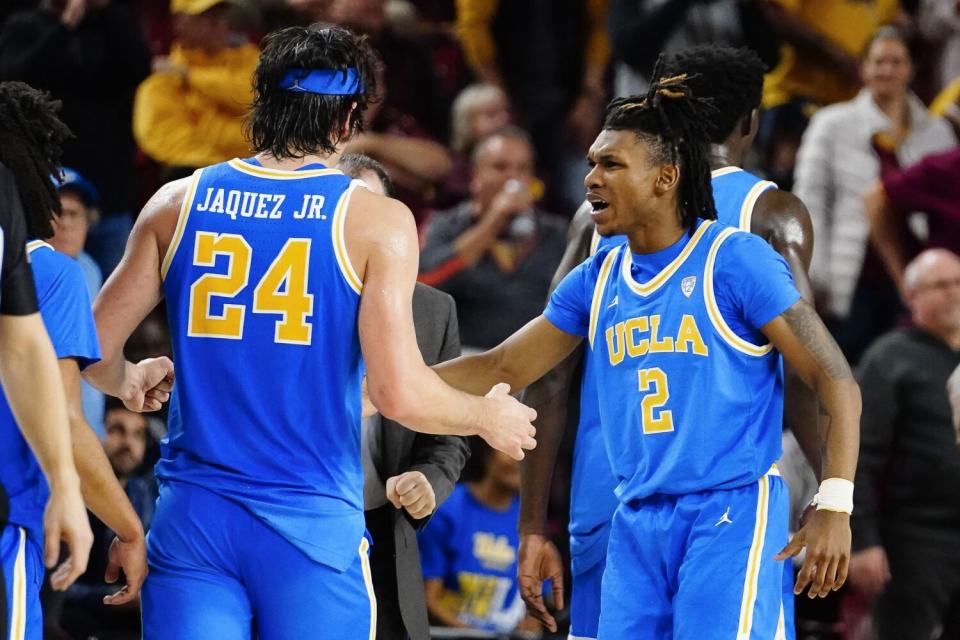 UCLA's Jamie Jaquez Jr.  is greeted by Dylan Andrews after hitting a 3-pointer against Arizona State.