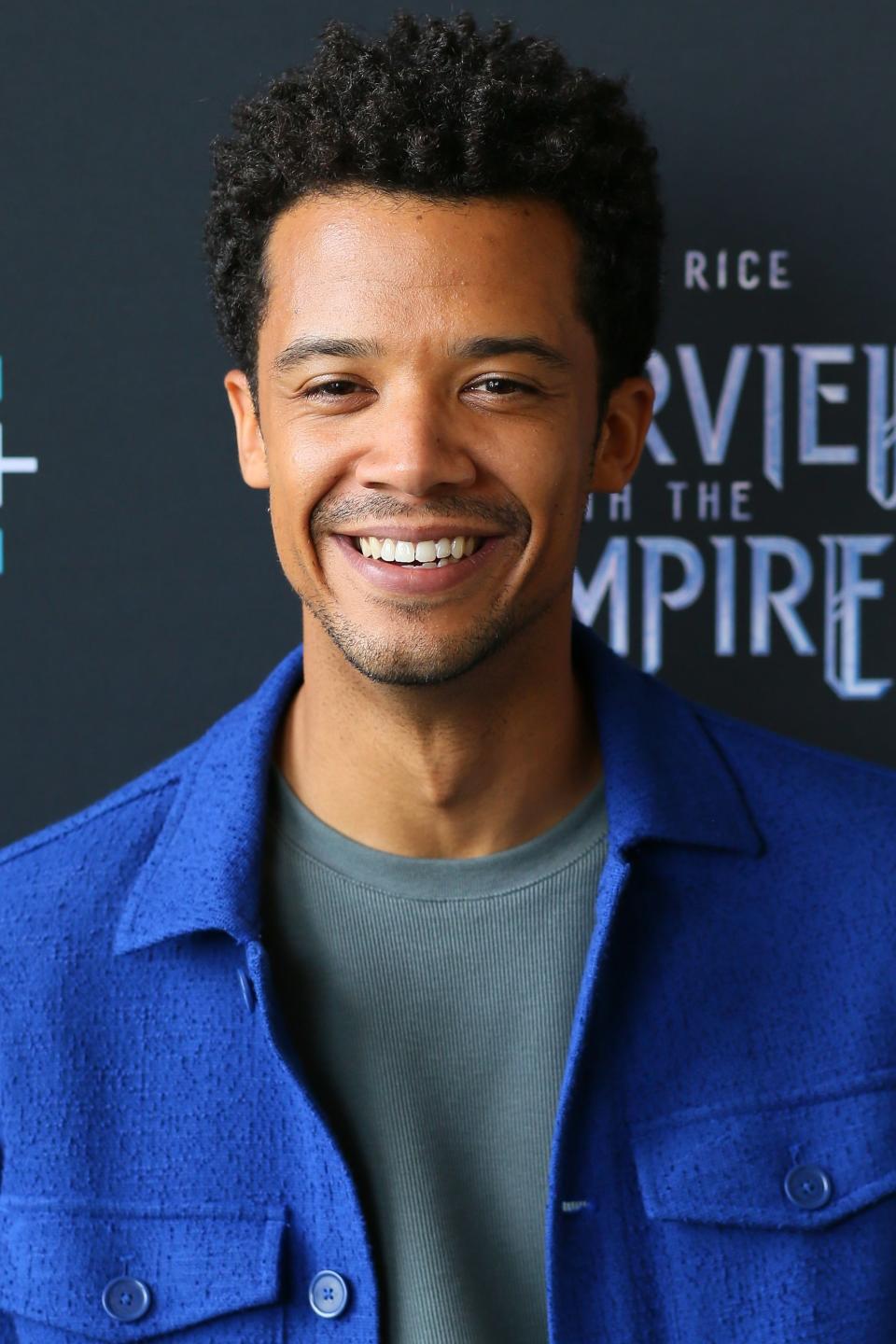 Jacob in a blue jacket smiling at a promotional event