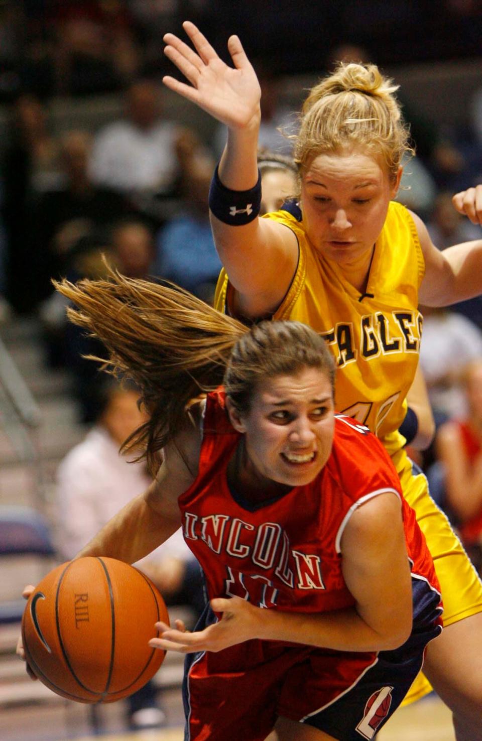 Lincoln basketball star Bethany O'Dell holds onto a rebound in front of Barrington's Emily Neubauer during the Division II championship game in April 2006.