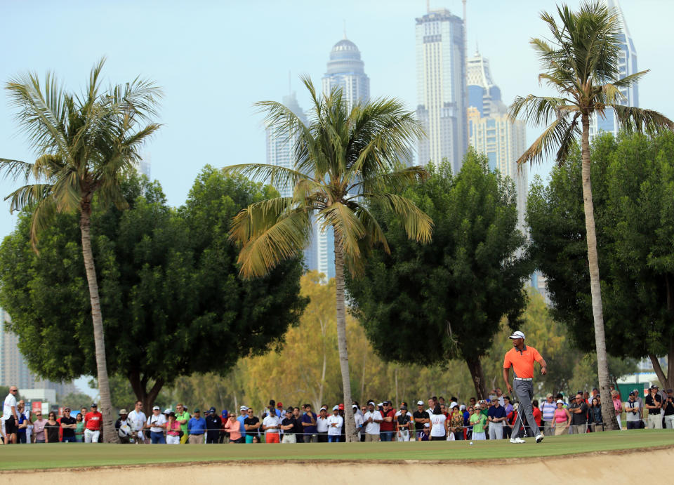 Tiger Woods of the U.S. lines up a putt on the 14th hole during the third round of the Dubai Desert Classic golf tournament in Dubai, United Arab Emirates, Saturday, Feb. 1, 2014. (AP Photo)