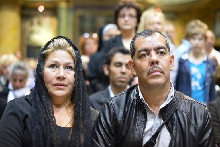 Costa Rican Floribeth Mora (L), who was cured of a serious brain condition by a miracle attributed to late Pope John Paul II, attends a mass at the San Stanislao church in Rome on April 24, 2014