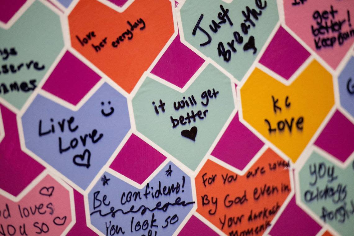 A variety of messages written on heart-shaped notes are seen as part of the heart called “Pathway to Healing” by artist Matt Defamers.