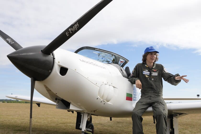 Seventeen year old Anglo-Belgian pilot, Mack Rutherford, speaks with the media after landing at the Buzet airfield in Pont-A-Celles, Belgium, Tuesday, Aug. 23, 2022. Rutherford landed in Belgium before flying on to Slovakia and Sofia, Bulgaria, for the final leg of his Guinness World Record attempt to be the youngest person to the fly around the world solo in a small plane. (AP Photo/Virginia Mayo)