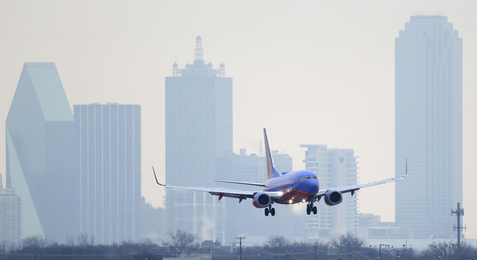 FILE - In this Feb. 3, 2014 file photo, a Southwest Airlines jet plane lines up for a landing at Love Field in Dallas. British billionaire Richard Branson on Tuesday, May 6, 2014 said that Virgin America should get gates at Love Field, near downtown Dallas, to create competition for Southwest Airlines, which controls most of the gates there. The U.S. Justice Department agrees. (AP Photo/LM Otero)