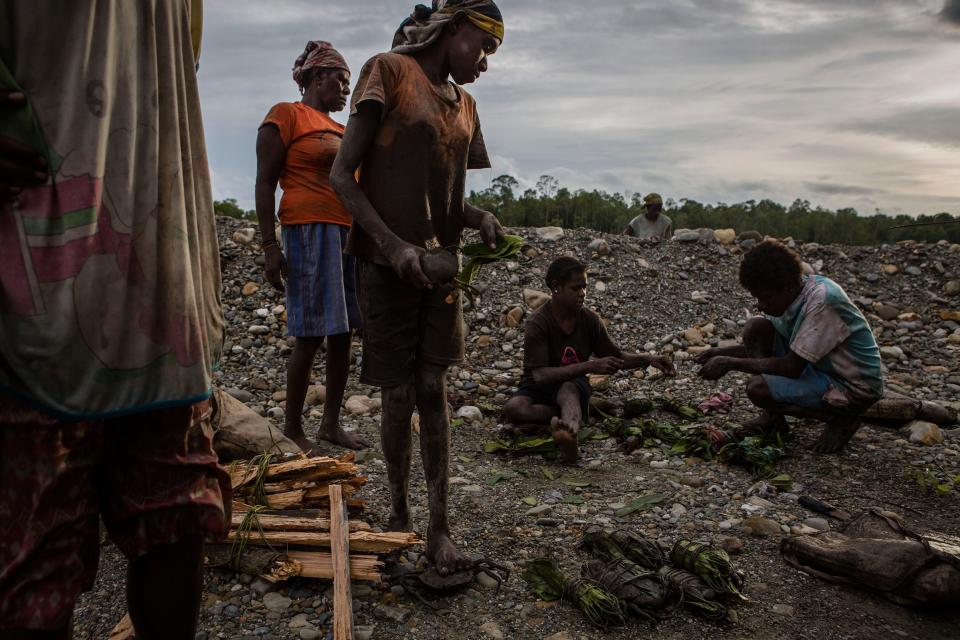 Locals work to catch crabs from the mining operations site in Timika, Papua Province, Indonesia, on Feb. 2, 2017