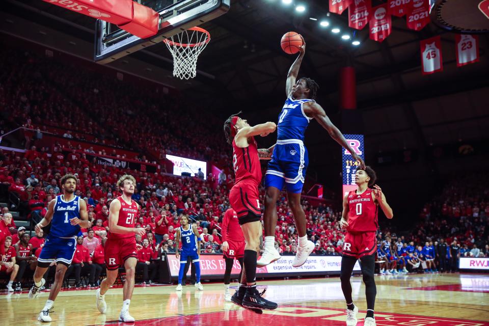 Seton Hall Pirates guard Kadary Richmond (0) attempts to dunk past Rutgers Scarlet Knights guard Caleb McConnell (22) in the first half at Jersey Mike's Arena.