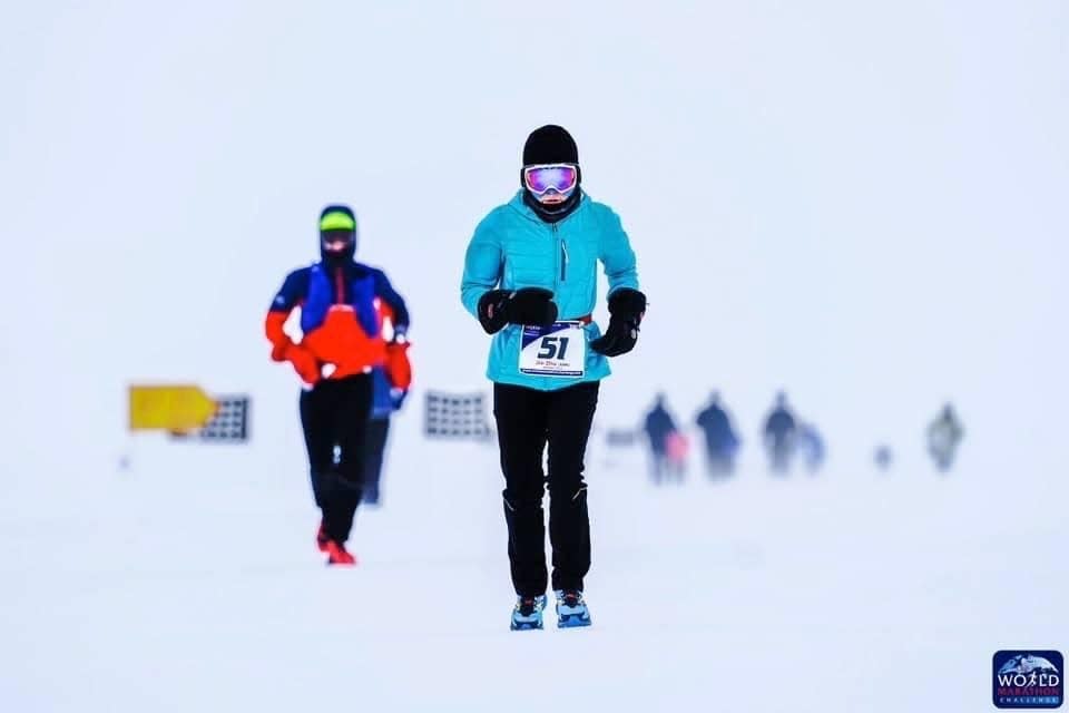 Jin Zhu, 59, of Farmington Hills is No. 51 as she runs a marathon in Antarctica, with a wind chill well below zero, in this month's World Marathon Challenge.