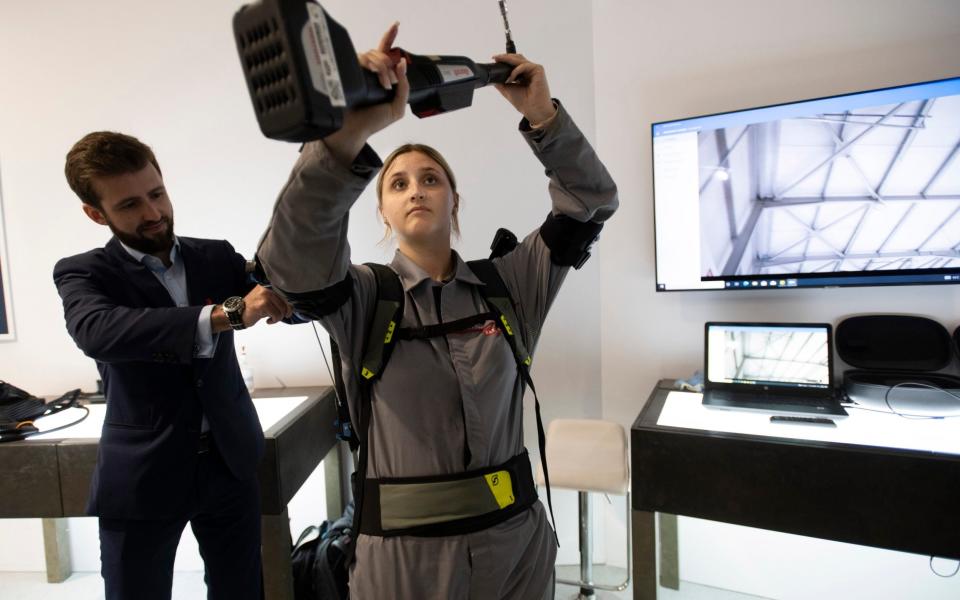 RAF Typhoon Support , BAE systems. Apprentice Typhoon maintainance engineer Alisha Wherrit tries out a prototype exo-skelital system to enable rapid servicing and maintainance of Typhoon skins and panels, - David Rose for the Telegraph