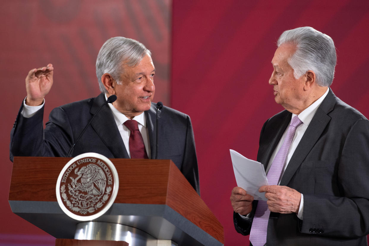 Mexico's President Andres Manuel Lopez Obrador chat with the head of the Federal Electricity Commission (CFE) Manuel Bartlett during an event where the government reached a deal with companies to renegotiate the terms of natural gas pipeline contracts signed under the previous administration, at National Palace in Mexico City, Mexico August 27, 2019. Press Office Andres Manuel Lopez Obrador/Handout via REUTERS ATTENTION EDITORS - THIS IMAGE WAS PROVIDED BY A THIRD PARTY