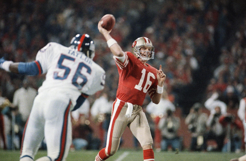 File-This Dec. 1, 1986, file photo shows San Francisco 49ers quarterback Joe Montana (16), passing before New York Giants linebacker Lawrence Taylor (56), can reach him during the first quarter of their NFL game in Candlestick Park, San Francisco. Members of a special panel of 26 selected all of them for the position as part of the NFL's celebration of its 100th season. All won league titles except Marino. All are in the Hall of Fame except Brady and Manning, who are not yet eligible. On Friday, Dec. 27, 2019, quarterback was the final position revealed for the All-Time Team. (AP Photo/Paul Sakuma, File)