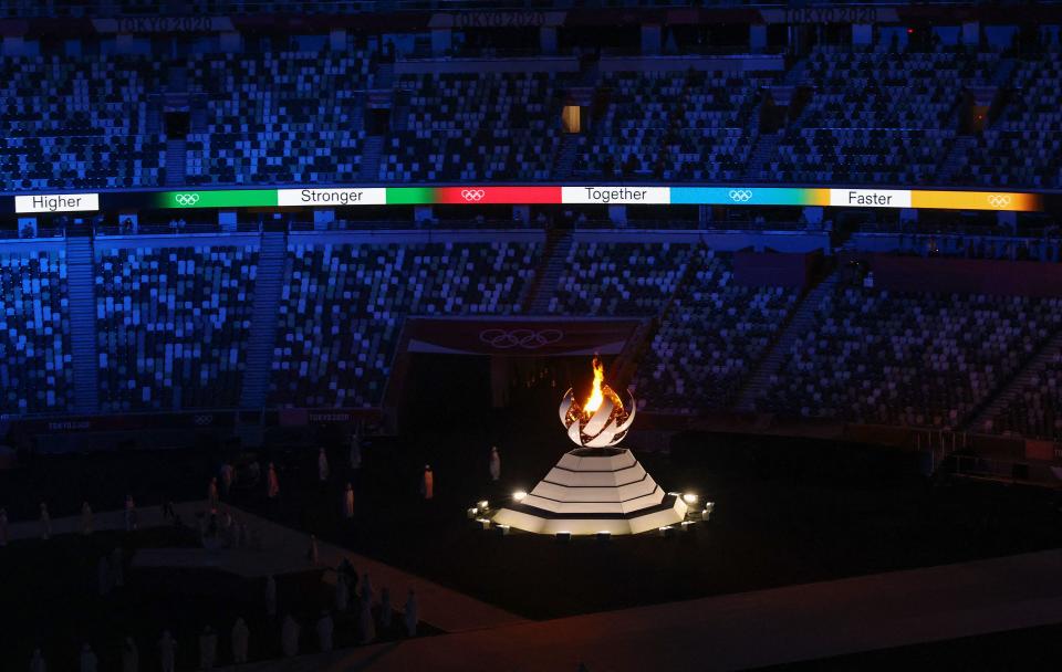 <p>A general view shows the Olympic cauldron and the Olympic flame during the closing ceremony of the Tokyo 2020 Olympic Games, on August 8, 2021 at the Olympic Stadium in Tokyo. (Photo by Behrouz MEHRI / AFP) (Photo by BEHROUZ MEHRI/AFP via Getty Images)</p> 