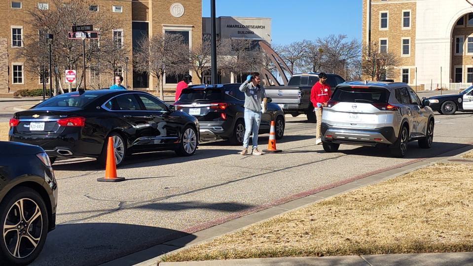 Volunteers guide cars through during a previous Medical Cleanout event at the Texas Tech Health Sciences Center. The next event will be held at the pharmacy school on Saturday.