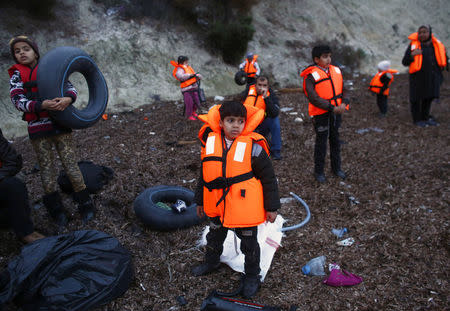 Migrant children wearing life jackets wait for a dinghy to sail off for the Greek island of Lesbos from the Turkish coastal town of Dikili, Turkey, April 6, 2016. REUTERS/Murad Sezer