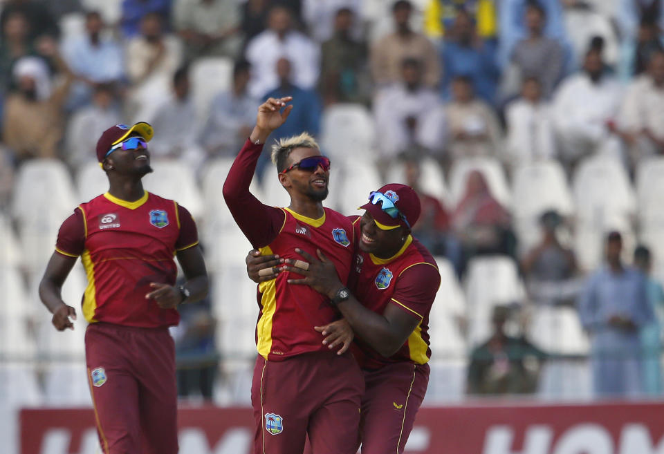 West Indies' Nicholas Pooran, center, celebrates with teammates after taking the wicket of Mohammad Rizwan during the third and final one-day international cricket match between Pakistan and West Indies at the Multan Cricket Stadium, in Multan, Pakistan, Sunday, June 12, 2022. (AP Photo/Anjum Naveed)