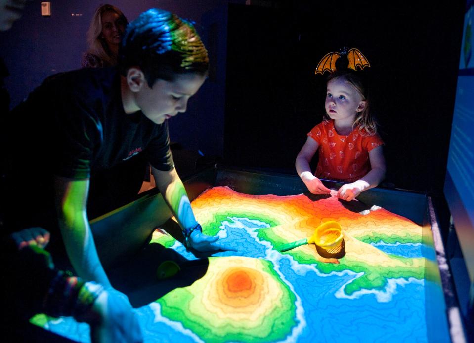 Oliver Diebold, 8, and Aster Quinn, 2, play at the watershed exhibition in May at the Cox Science Center and Aquarium in West Palm Beach. The center will hold its Black Tie Masquerade on Oct. 27.