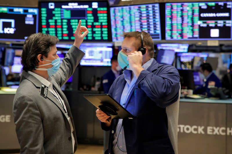 Traders work on the floor of the NYSE in New York