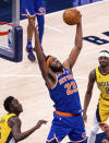 New York Knicks center Mitchell Robinson (23) grabs a rebound during the second half of an NBA basketball game against the Indiana Pacers in Indianapolis, Saturday, Jan. 2, 2021. (AP Photo/Doug McSchooler)