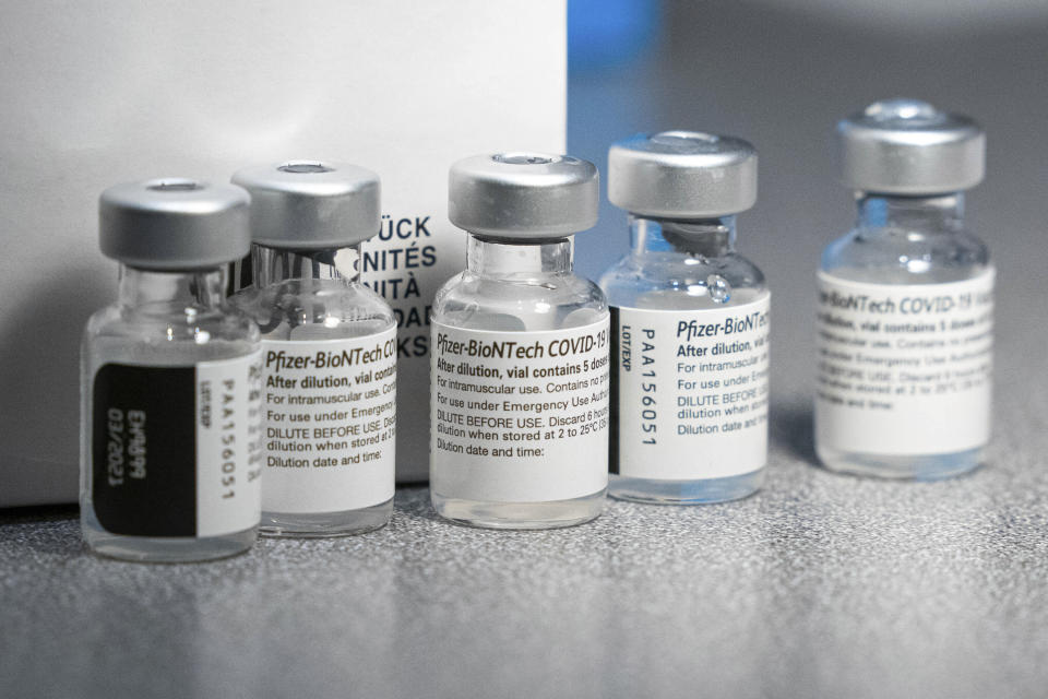 Vials of the Pfizer-BioNtech COVID-19 vaccine, each containing five doses, sit on a table Wednesday, Dec. 16, 2020, during a vaccine clinic at Providence Alaska Medical Center in Anchorage, Alaska.(Loren Holmes/Anchorage Daily News via AP, Pool)