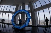 A worker stands inside the "City Pulse" interactive display in the One World Observatory observation deck on the 100th floor of the One World Trade center tower in New York during a press tour of the site May 20, 2015. One World Observatory will open to the public on May 29. (REUTERS/Mike Segar)