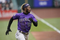 Colorado Rockies' Raimel Tapia runs in to score during the first inning of a baseball game against the St. Louis Cardinals Saturday, May 8, 2021, in St. Louis. (AP Photo/Jeff Roberson)