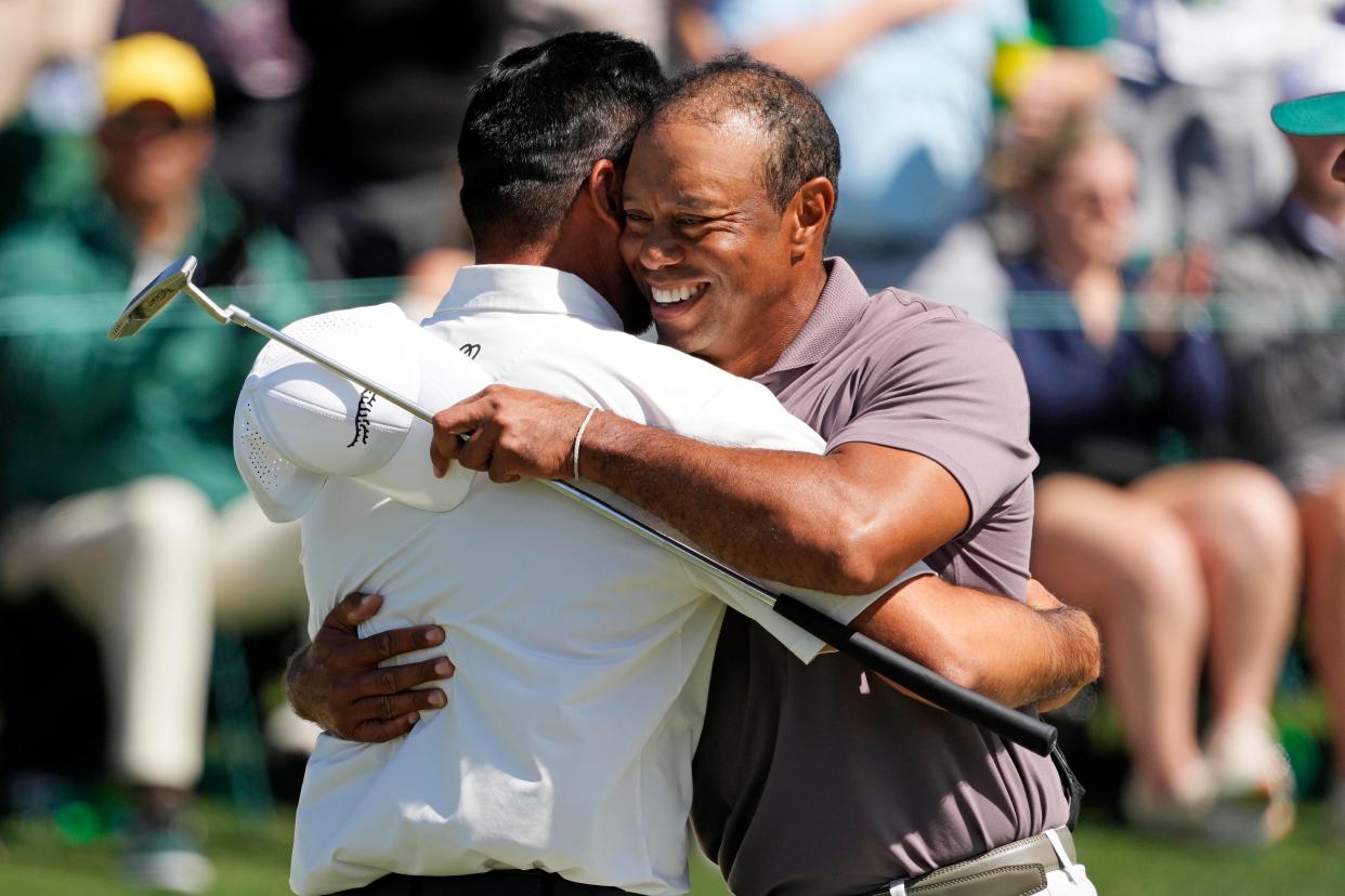 Jason Day and Tiger Woods hug after completing the second round of the 2024 Masters Tournament.