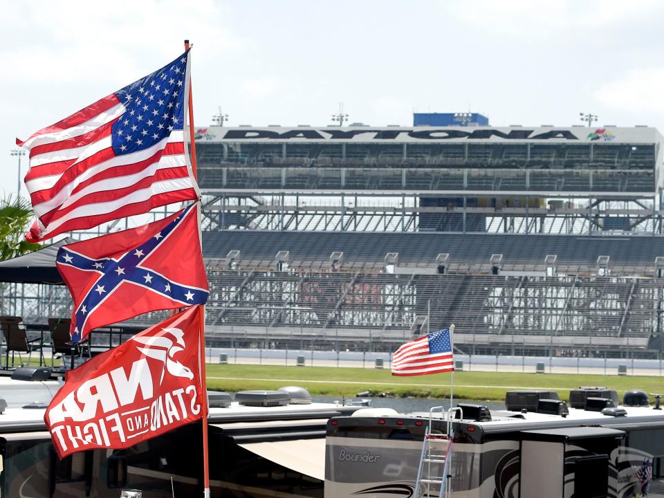 FILE - In this July 4, 2015, file photo, confederate and American flags fly on top of motor homes at Daytona International Speedway in Daytona Beach, Fla. Bubba Wallace, the only African-American driver in the top tier of NASCAR, calls for a ban on the Confederate flag in the sport that is deeply rooted in the South. (AP Photo/Phelan M. Ebenhack, File)