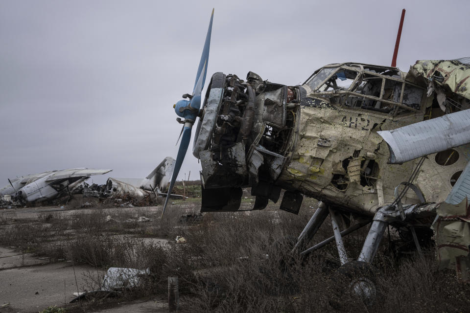 An aircraft that was destroyed during fighting between Ukrainian and Russian forces is seen at the Kherson international airport in Kherson, Ukraine, Friday, Dec. 2, 2022. (AP Photo/Evgeniy Maloletka)